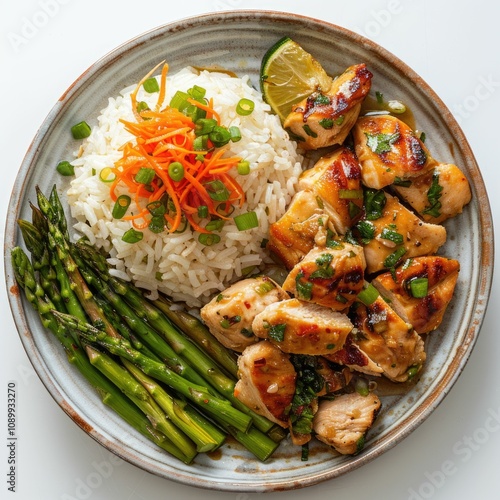 Chicken and rice with asparagus and carrot on plate.