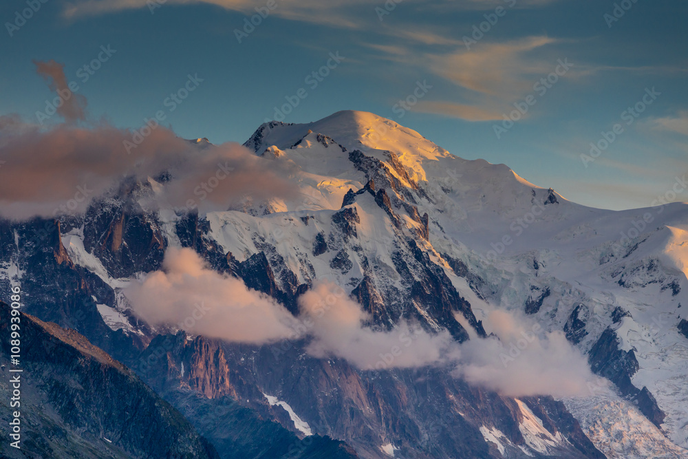 Naklejka premium Mont Blanc snow summit, the highest peak in Europe, located in the Alps. A stunning landscape featuring snow-covered peaks, rugged terrain, and vast skies, showcasing the majestic beauty of Alps