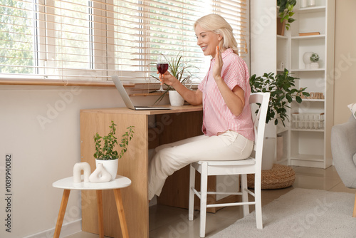 Mature woman with wine and ...
