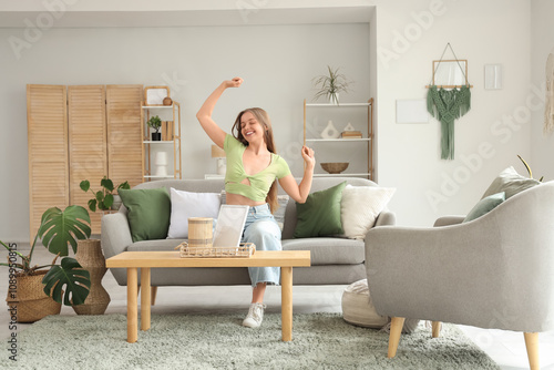 Happy young woman dancing a...