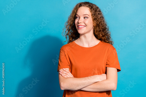 Photo of positive cheerful girl cross arms look profile side isolated blue color background photo