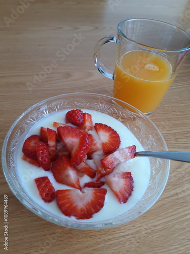 breakfast with Fresh Orange juice and strawberries in yogurt