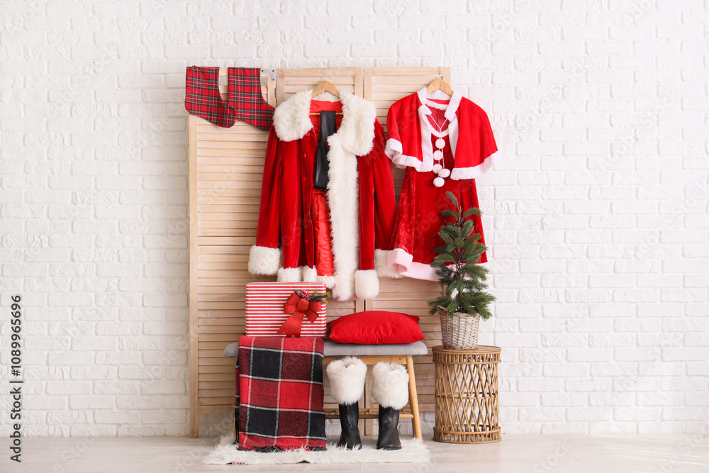 Obraz premium Interior of hall with Santa costumes, folding screen and bench
