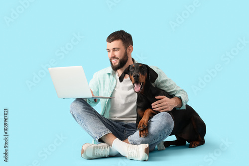 Young man with laptop and D...