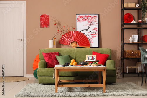 Interior of living room with green sofa, table and decor for Chinese New Year celebration photo