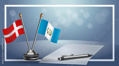 Denmark and Guatemala National flags on small table with bokeh background, cooperative relationship