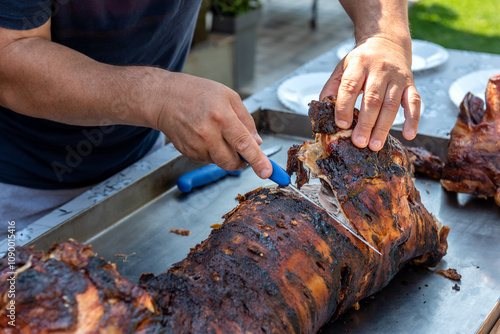 Cutting whole piglet roast