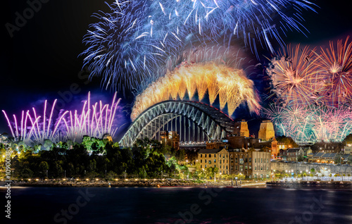 Photography Sydney Harbour Bridge New Years Eve fireworks, colourful NYE fire works lighting the night skies with vivid multi colours NSW Australia