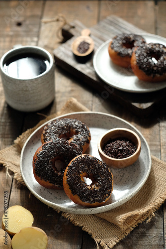 Potato donut (doughnut) donat sweet, made with mashed potatoes or potato starch instead of wheat flour, with chocolate sprinkles topping, Oily textured. photo