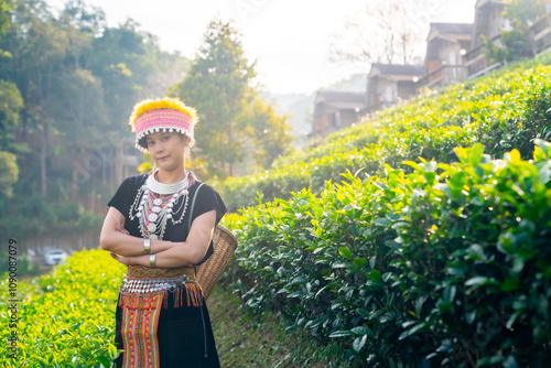 Portrait of Happy Asian woman farmer working and growing tea plant on the mountain in Thailand. Hill tribes women farm worker in traditional clothing harvesting organic tea leaves at tea plantation. photo