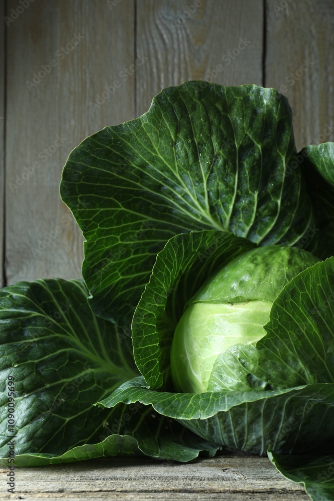 Obraz premium One ripe head of cabbage on wooden table, closeup
