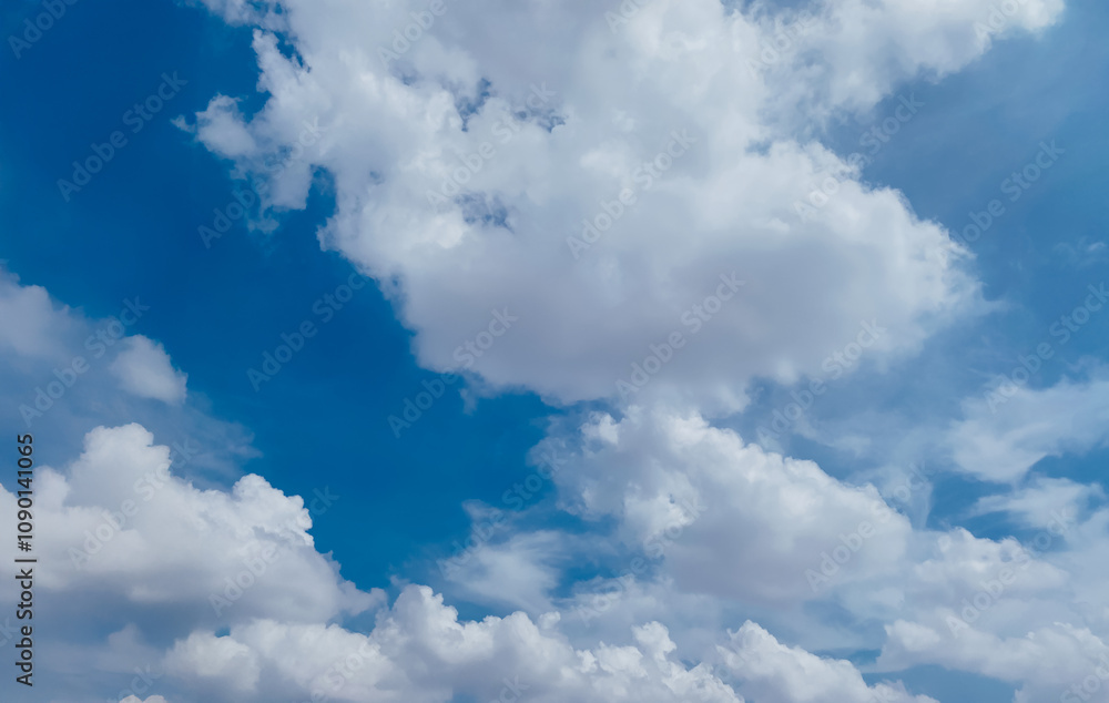 Obraz premium Sky background image. Bottom up view of beautiful blue sky and white clouds at noon in summer.