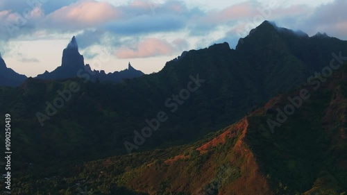 Golden hour sunset Cooks Opunohu Bay Moorea island French Polynesia aerial drone clouds covering Mount Mauaroa Tohivea Rotui clouds lagoon coral reef waves Pacific Ocean circle right parallax photo