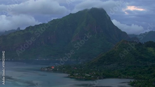 Purple sunset dusk Mount Mauaroa Tohivea Rotui Haapiti Cooks Opunohu Bay Moorea island French Polynesia aerial drone jagged mountains boats lagoon coral reef waves Pacific Ocean circle left parallax photo