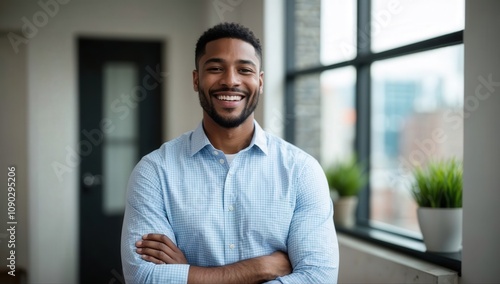 Smiling cheerful young adult african american ethnicity man in casual attire looking at camera standing at home office background. Happy confident black guy headshot face front close up portrait