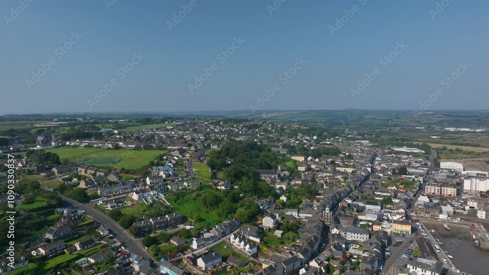 Youghal, County Cork, Ireland, September 2024. Drone pushes forward in panoramic establishing overview showcasing the winding roads of town and iconic College grounds adjacent to the historic walls. Youghal, County Cork, Ireland, September 2024. Drone pushes forward in panoramic establishing overview showcasing the winding roads of town and iconic College grounds adjacent to the historic walls.