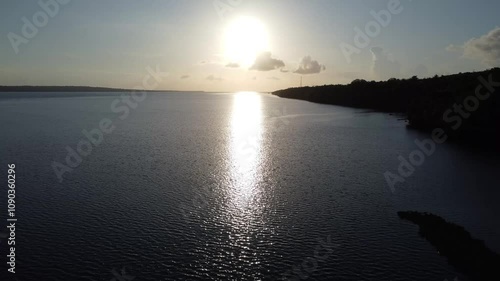 A beautiful sunset over the sea. Aerial view of sun reflections in the water.