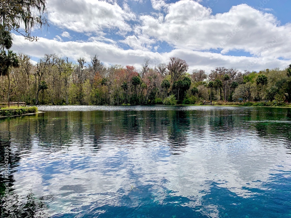 Fototapeta premium Lake view with surface reflections and bright sky
