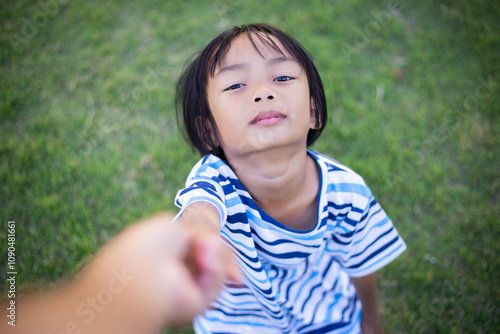 A sad little girl sitting alone outside photo