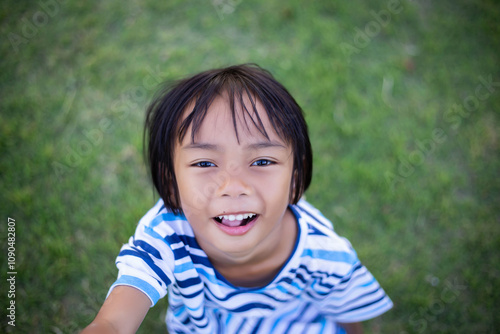 A sad little girl sitting alone outside