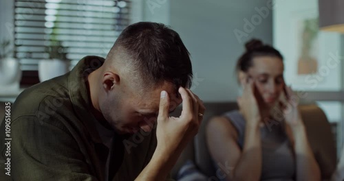 A family quarrel. A man and a woman are fighting while sitting on the couch, they look offended