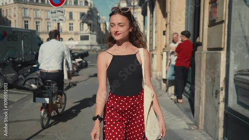 Beautiful young woman walking in the streets of Paris during summer