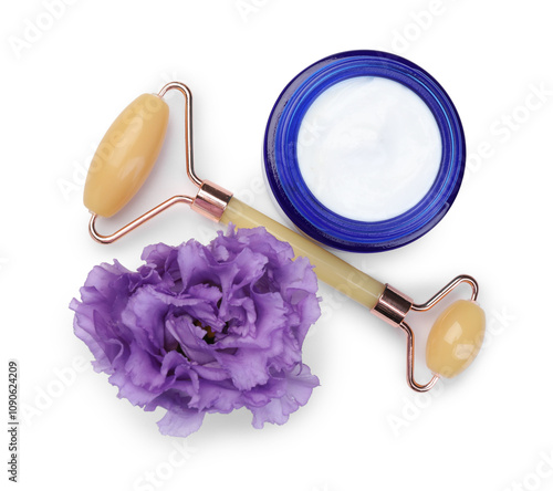 Face roller, cosmetic product and flower isolated on white, top view