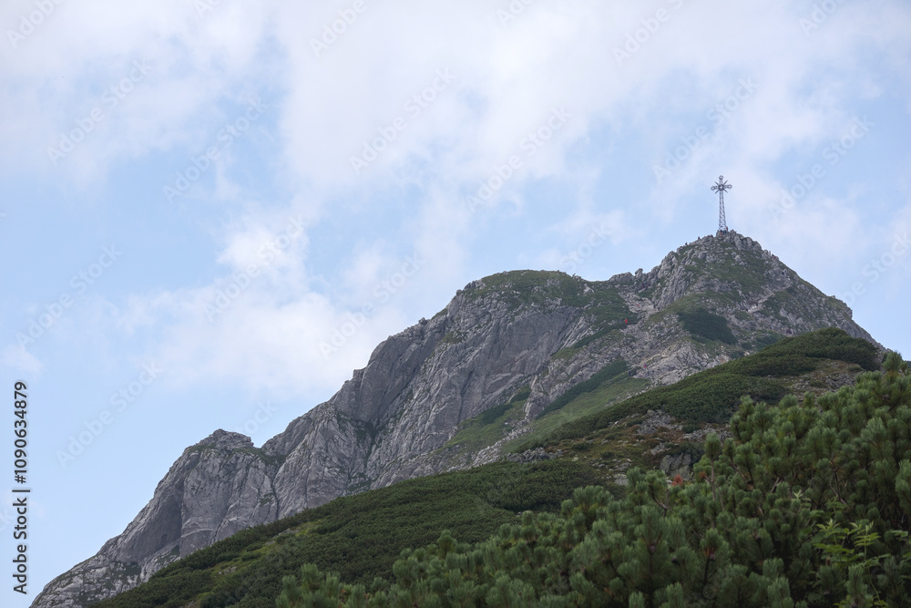 Fototapeta premium Natural landscape in the mountains, one of which has a cross