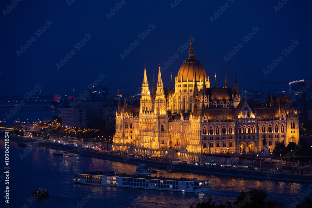 Obraz premium Hungarian Parliament building during blue hour. Night landscape in Budapest with the historical landmark building of the parliament next to Danube river.