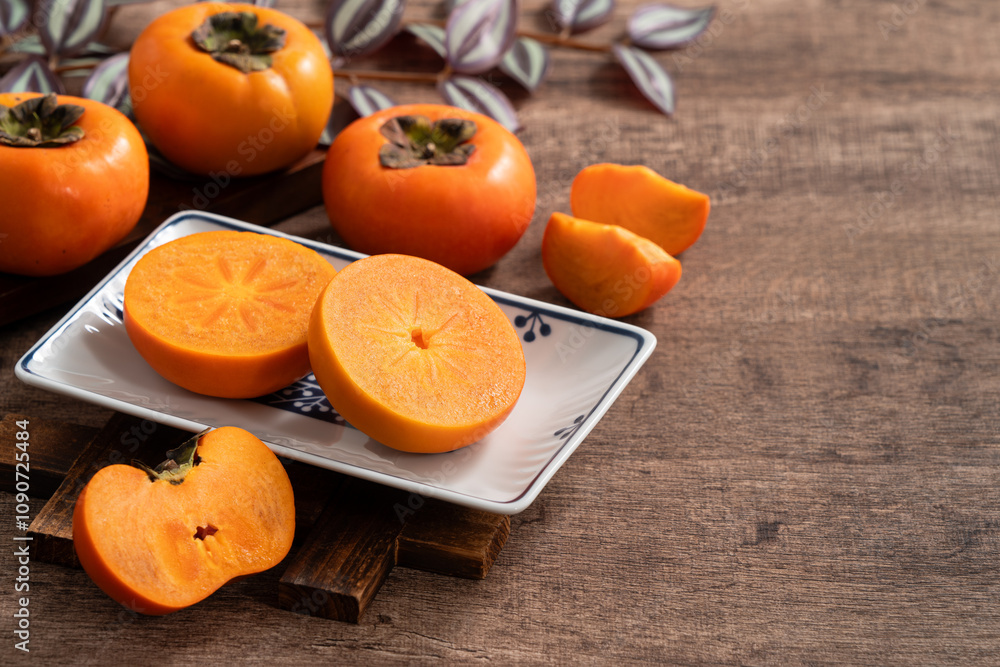 Fresh ripe persimmon fruit on wooden table background. Fresh ripe persimmon fruit on wooden table background.