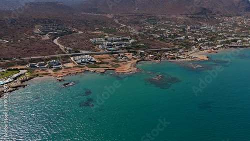 Aerial - coastal view of Chersonissos, Crete island's serene seaside, Greece photo