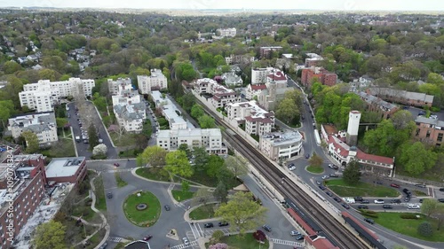 Drone side-tracking shot of Bronxville’s railway in horizontal orientation, capturing a dynamic aerial perspective of train tracks and transportation infrastructure. photo