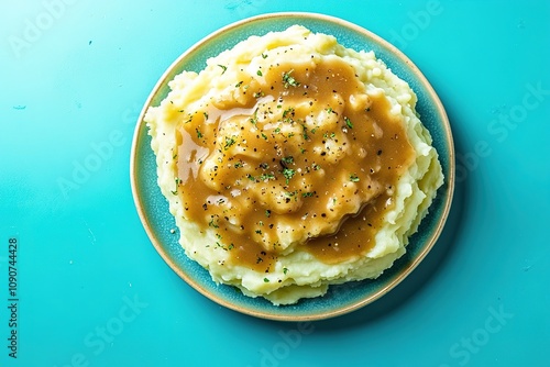 Mashed potatoes with gravy on blue background