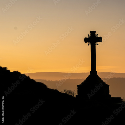 silhouette of a crucifx in sunset orange skyline cross view on a hill photo