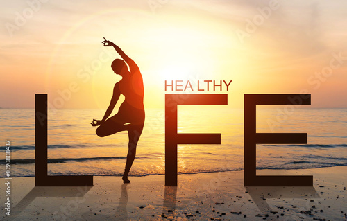 Silhouette of A woman practicing Yoga vrikshasana tree pose on tropical beach with sunrise sea and sky background, watching sunset, standing as a part of the wording life, concept for healthy life.