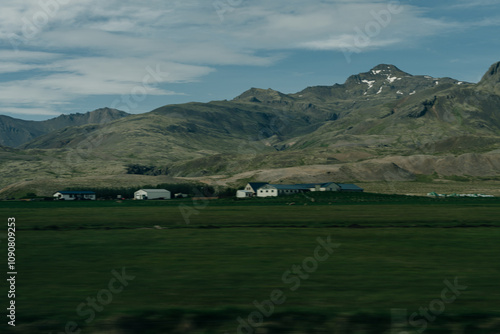 rural scene with grazing sheep,rustic farm buildings and a tranquil lake,capturing Iceland countryside charm. photo