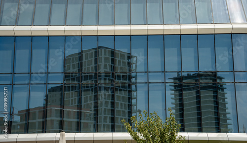 Budapest, Hungary - August 24, 2024: Contemporary architecture: skyscraper reflections in the glass of a new building.