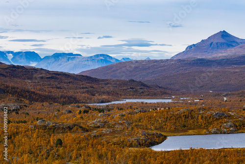 Autumn landscape of Kilpisjarvi, Finland, showcasing colorful foliage, serene lakes, and majestic mountains in the background. photo