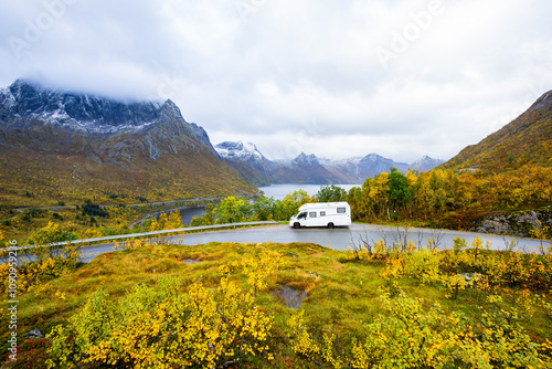 A motorhome parked by the road in the autumn landscape of Senja Island, Northern Norway, with fjords and mountains. photo