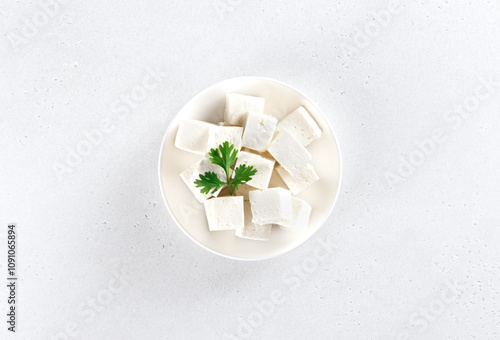 Indian paneer cheese made from fresh milk and lemon, cubes on white background. Top view.