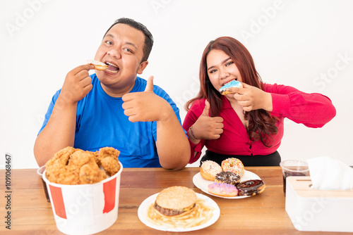 Wallpaper Mural A group of happy friends joyfully enjoying delicious fast food together at a dining table Torontodigital.ca