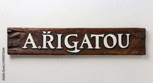 arigatou lettering on medieval ancient sign wooden board on plain white background photo