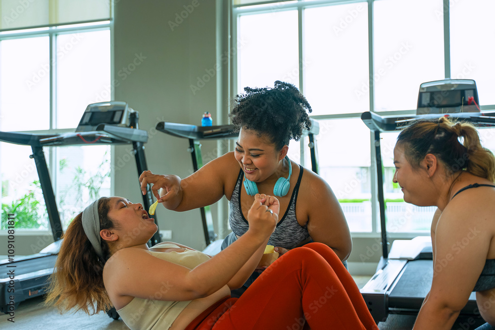 Obraz premium Plus size women workout at fitness center.