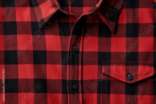 A close-up of a red and black plaid flannel shirt with a button-down collar, neatly arranged on a flat surface isolated on white background 