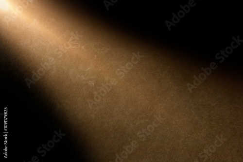 orange spotlight effect on stage or crepuscular rays or gods rays with particles  isolated on black background	