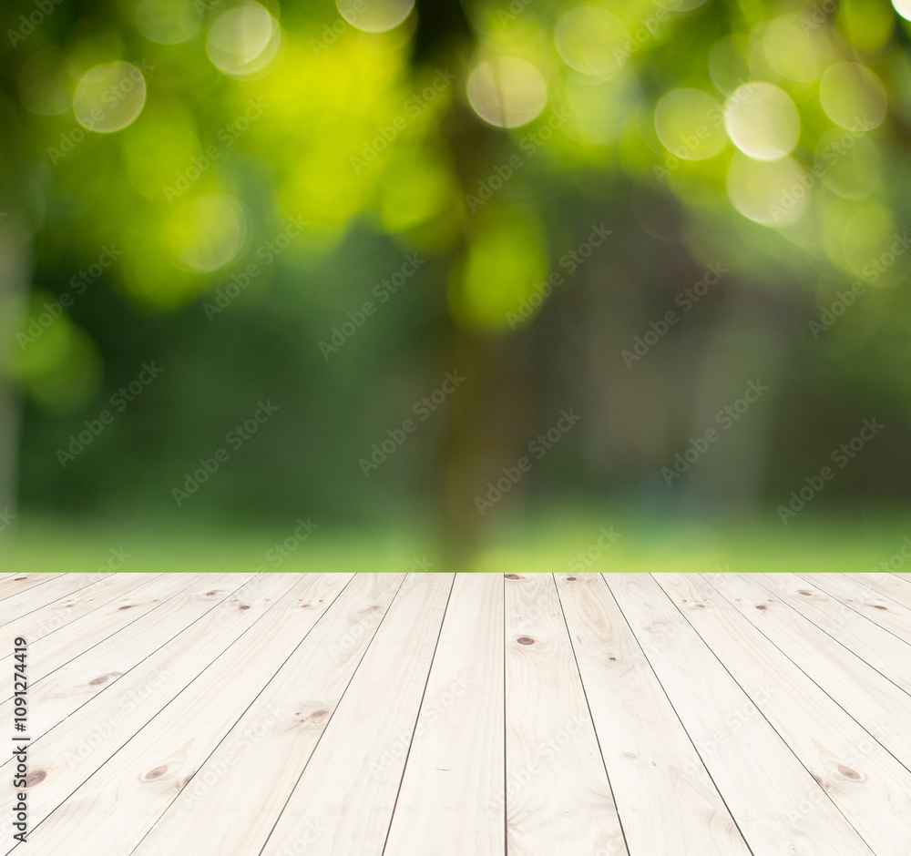 Wood floor with blurred trees of nature park background and summer season, product display montage Wood floor with blurred trees of nature park background and summer season, product display montage