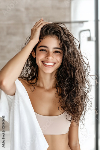 Smiling Woman with Curly Hair in Modern Bathroom Wrapped in White Towel