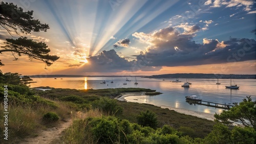 Captivating Crepuscular Rays Illuminating Poole Harbour at Sandbanks During Golden Hour, Showcasing Nature's Beauty and Tranquility in a Serene Coastal Landscape