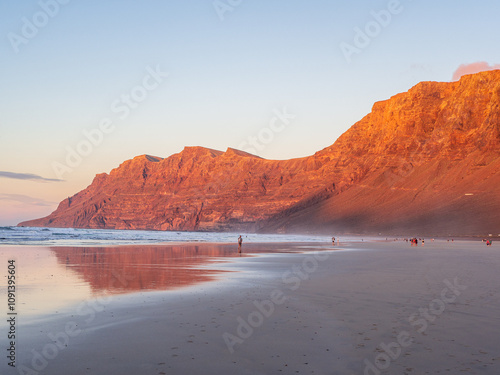 Paradise Beach of Famara at Sunset, Vibrant Red Rock Against Calm Sea, Lanzarote