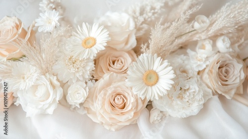 A beautiful arrangement of soft-colored flowers, including roses and daisies, on a light backdrop.